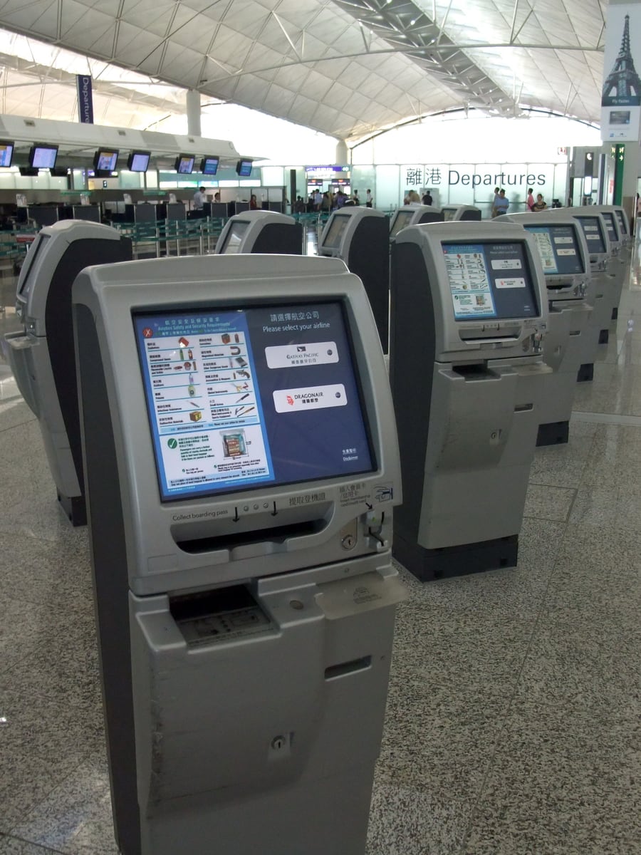 Row of airline self-check-in kiosks in the departures hall at Hong Kong International Airport