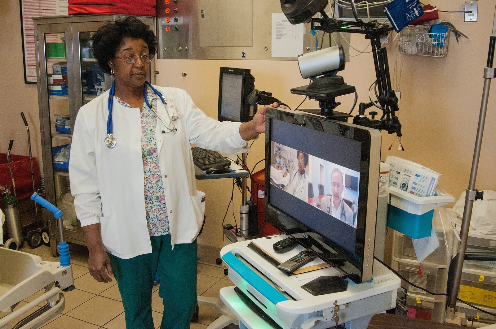 Nurse Lynn Grant beside a telemedicine and electronic medical records workstation in the R.J. Taylor Memorial Hospital emergency room