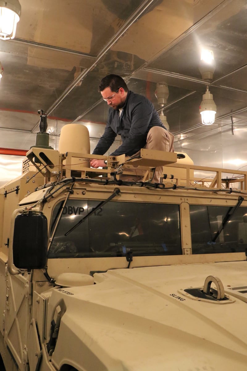 Engineer testing Humvee electronics in an environmental chamber