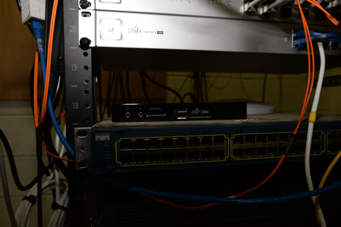 EFTA00002629 Server rack with multiple networking devices and cables connected showing a typical data center setup for cloud infrastructure, DevOps and platform engineering