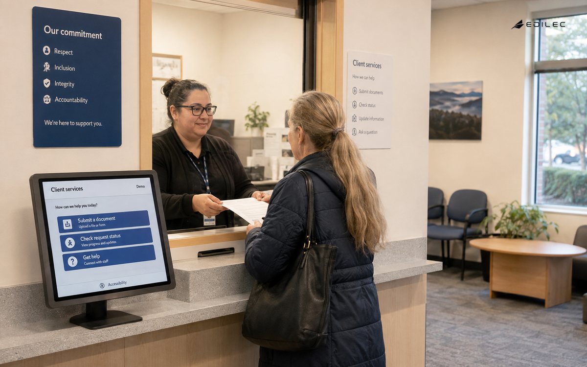 Client-services screen beside a document handoff at a reception counter.
