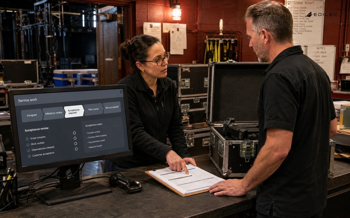 A technician and coordinator check returned equipment against a service acceptance record.