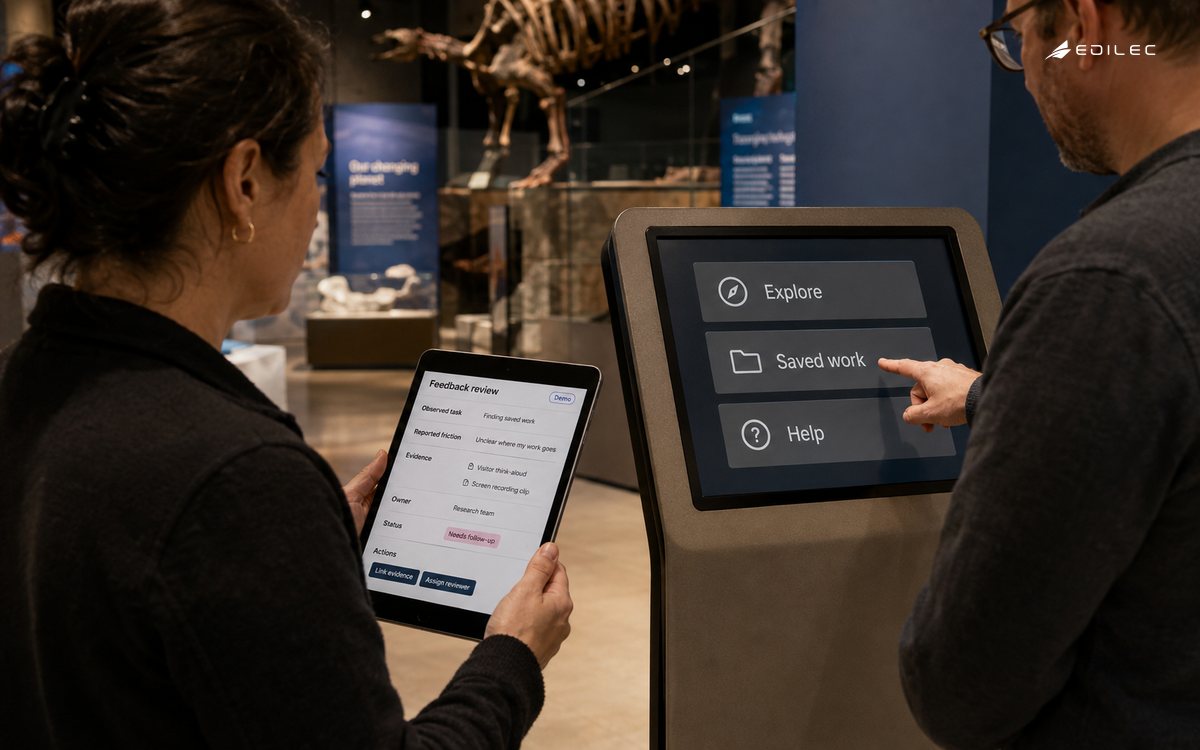 A researcher records feedback as a visitor demonstrates an exhibit task.