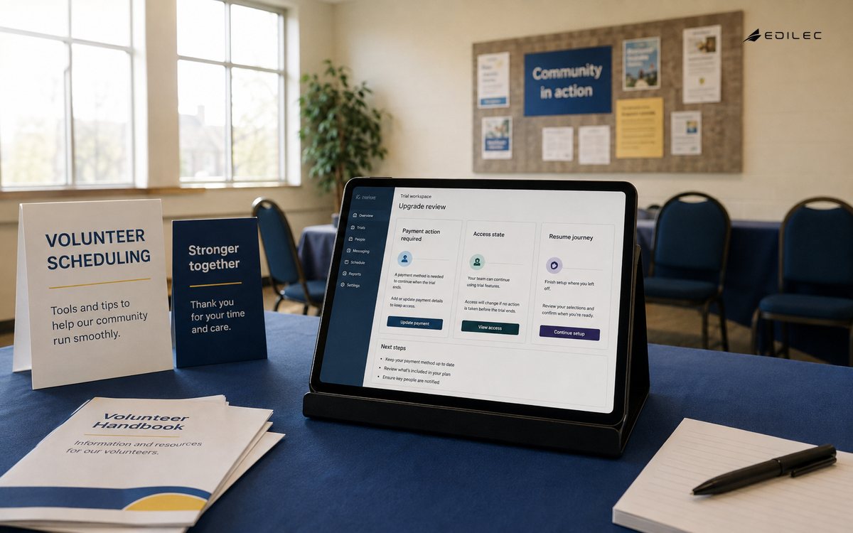 Wide photo of a volunteer scheduling demonstration desk in a community hall.